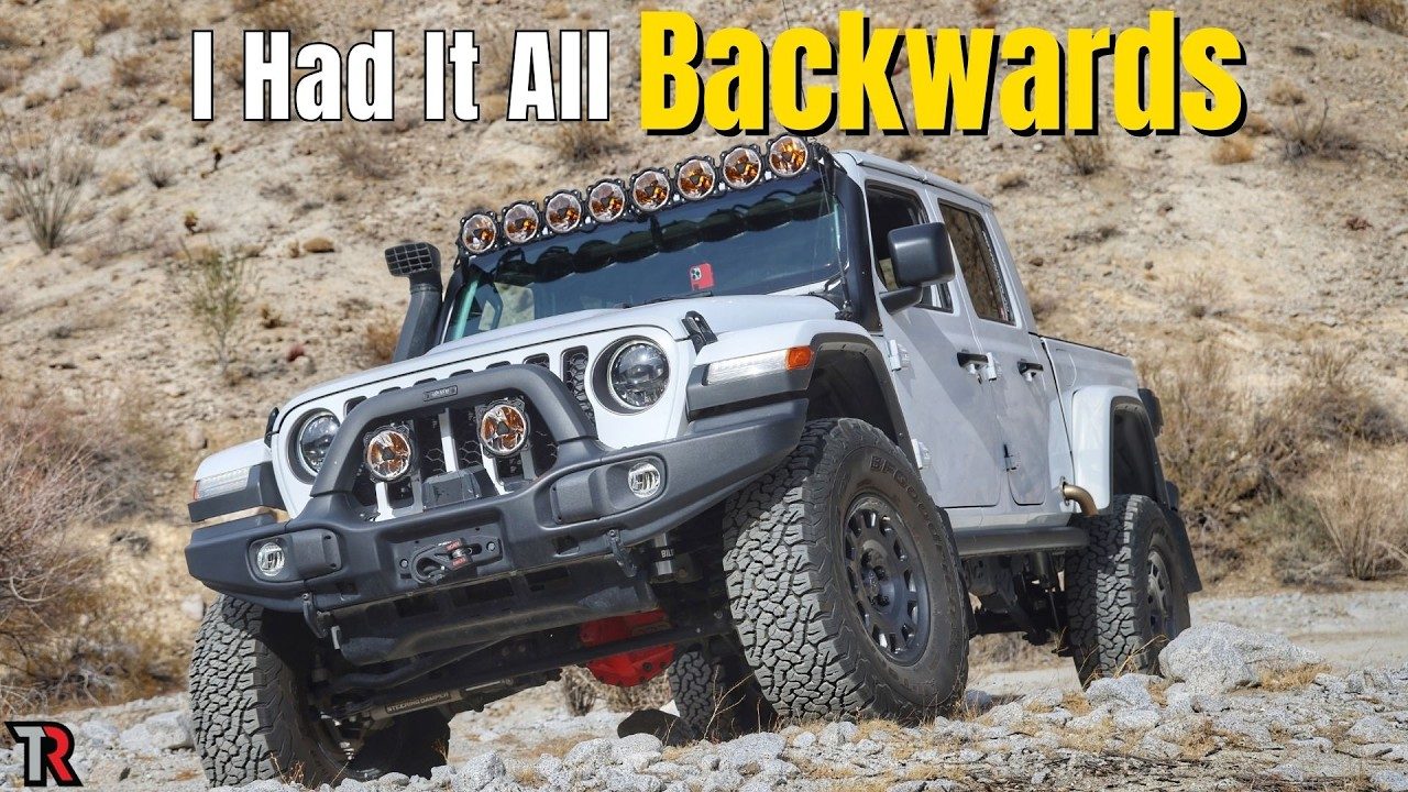 The Gladiator on a rocky hillside with two round amber-lensed pods on the front bumper, under the video title I Had It All Backwards